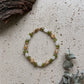 Handgefertigtes Earthlight Armband aus Peridot Mondstein und Rutilquarz mit goldfarbenen Edelstahlperlen