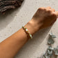 Handgefertigtes Earthlight Armband aus Peridot Mondstein und Rutilquarz mit goldfarbenen Edelstahlperlen